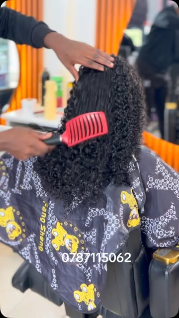 Dense defined curls being styled in the chair